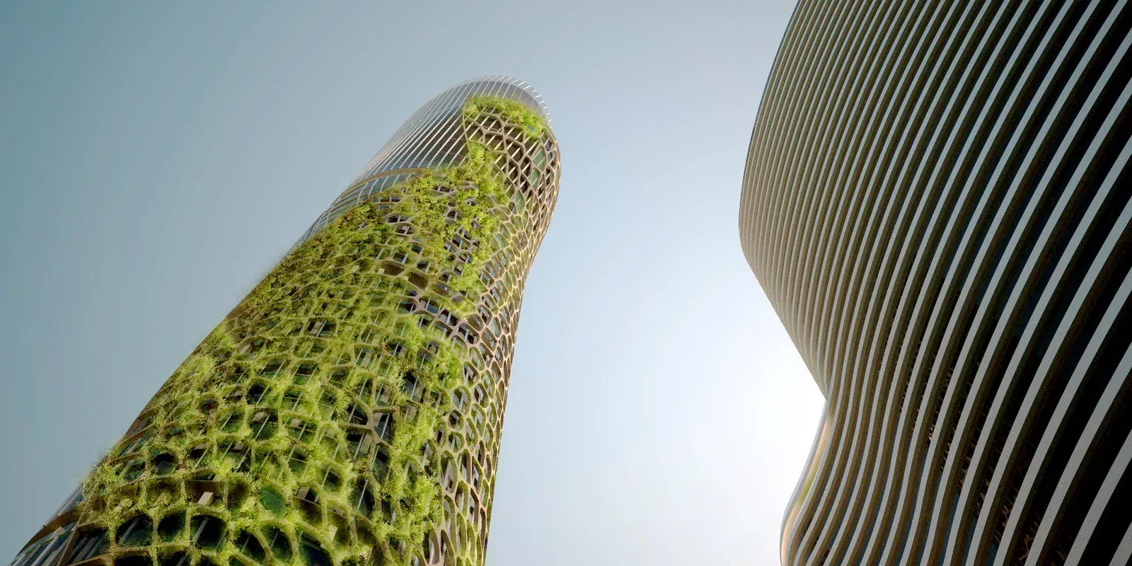 Upward view of the planted facade beside a neighbouring curved building