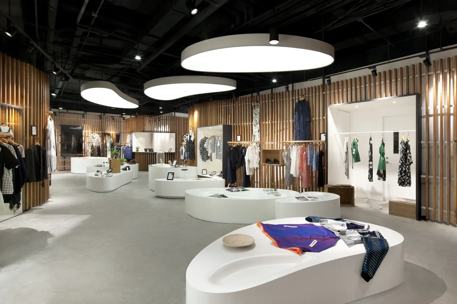 Sales floor with white display islands and light ceilings above