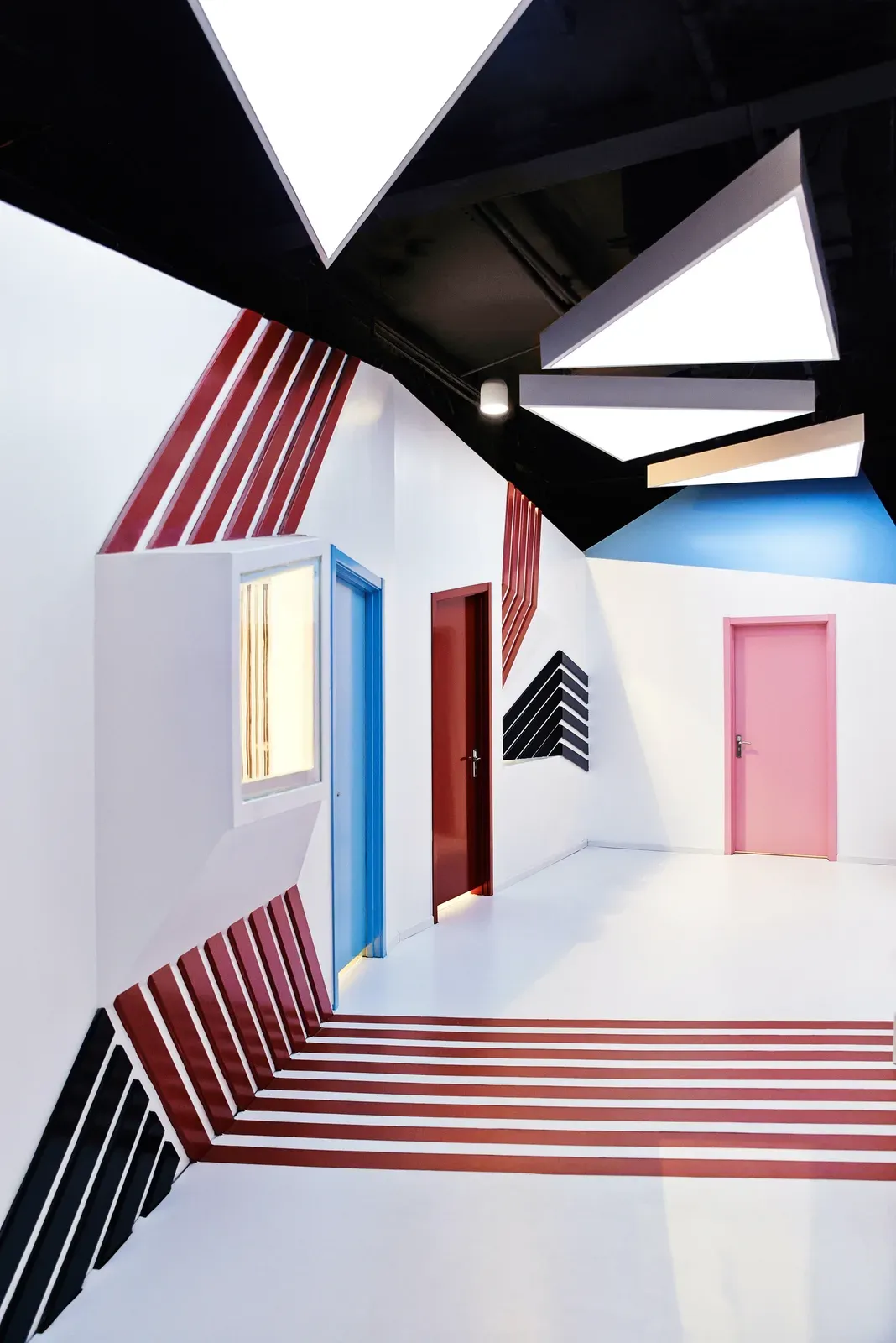 Classroom corridor with striped floor and coloured doors