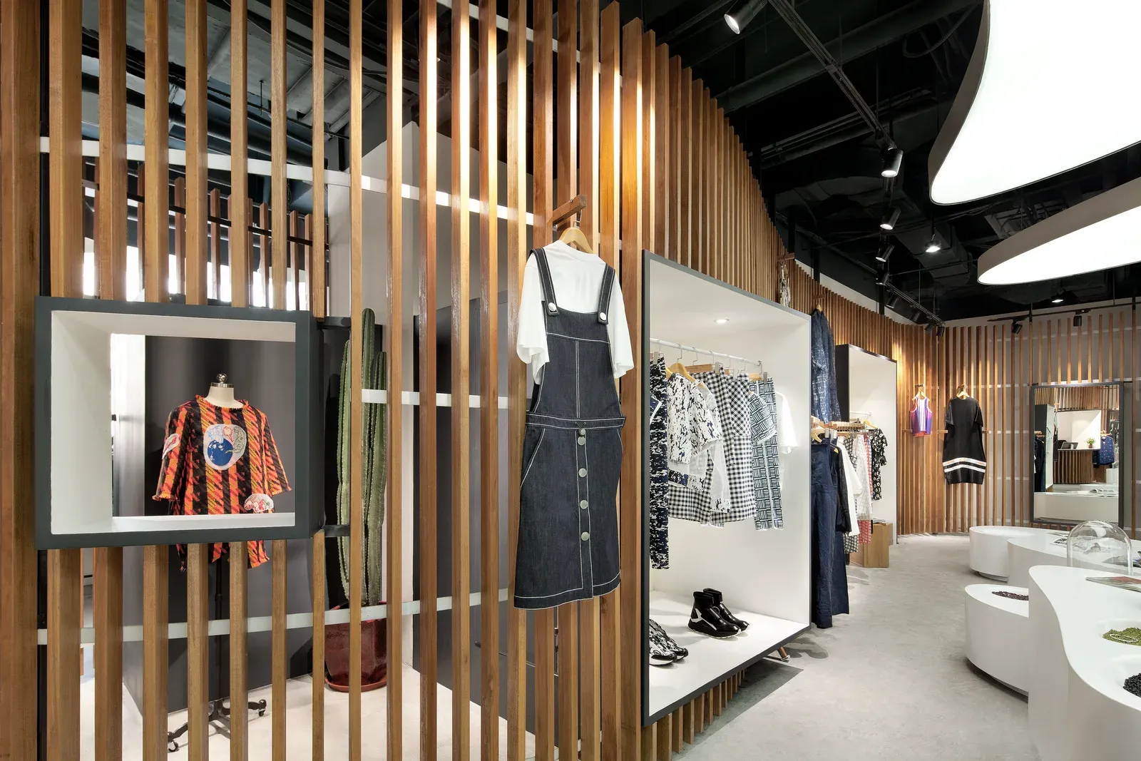 Screen wall with framed display windows and hanging clothes