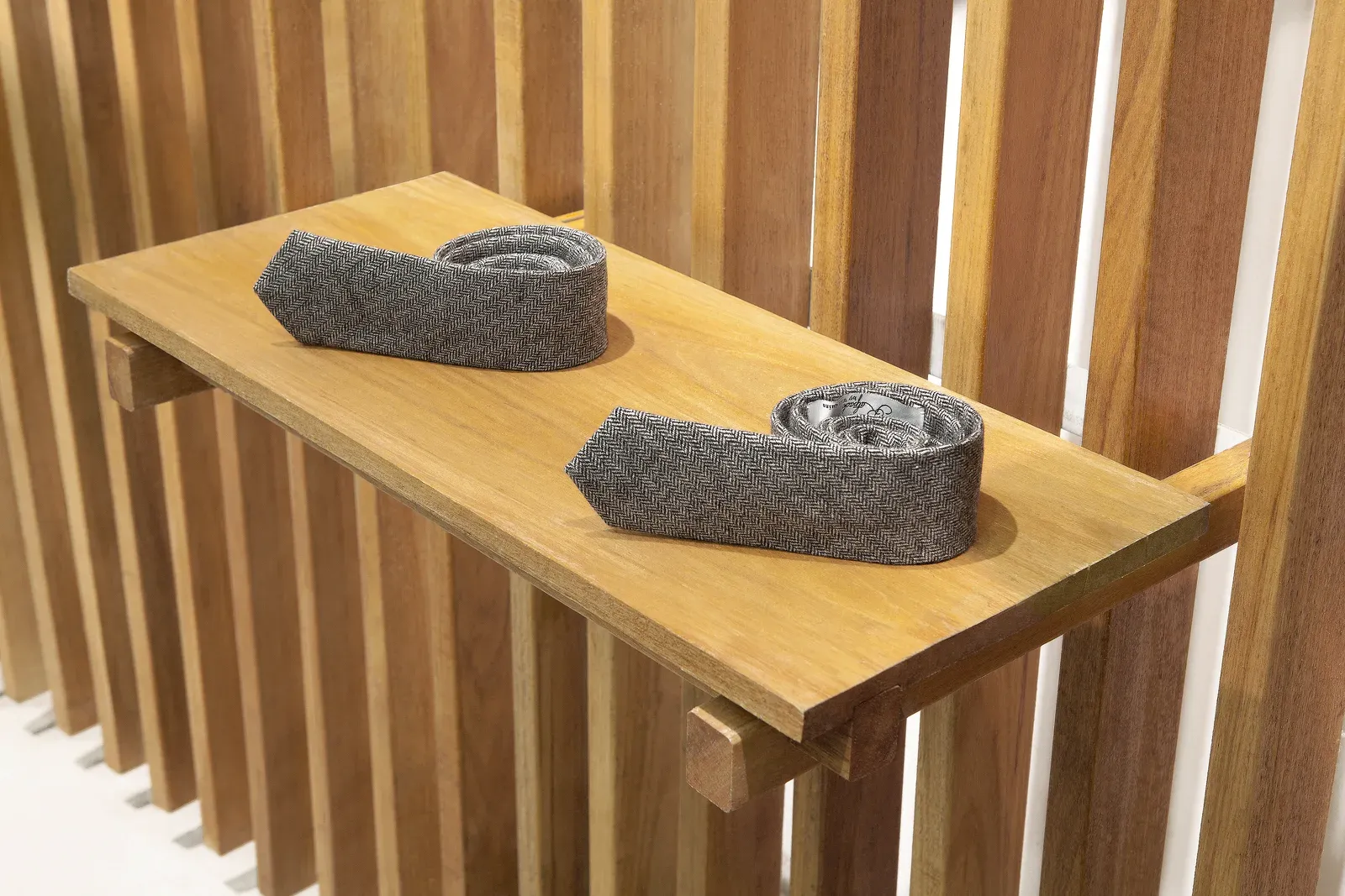 Timber shelf bracketed between the battens